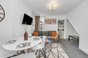 a living room with a table and a couch at Wherstead Rd House By Homestyles Hosts Short Lets & Serviced Accommodation Suffolk With Free Parking in Ipswich