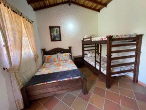 Postel nebo postele na pokoji v ubytování RANCHO SAN LUIS, Páramo