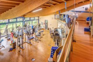 a gym with several treadmills and people in it at Mariva Dune Suites in San Vincenzo