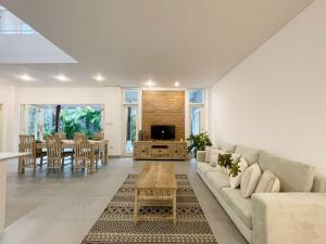 a living room with a couch and a table at Kubu Ramah Seminyak 3BR and 2BR Private Pool Villas in Seminyak