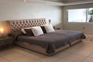 a bedroom with a large bed with a large headboard at Penthouse en Las Brisas Acapulco in Acapulco +66 photos