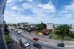 a view of a city street with cars on the road at Residencial Oceano Azul in Itapoa