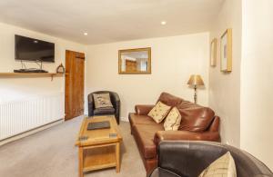 a living room with a couch and a table at Hedgehog Cottage Wheddon Cross in Wheddon Cross