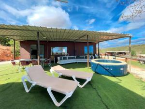 a patio with two lounge chairs and a hot tub at The Place in Albufeira