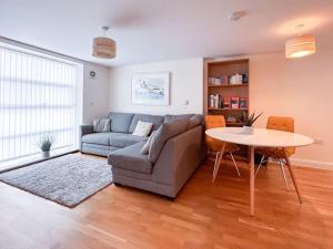 a living room with a couch and a table at Waterside apartment, central Falmouth, Vi-spring king bed, gated parking in Falmouth