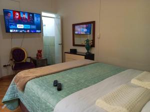A television and/or entertainment centre at Tripper Monkey House Miraflores