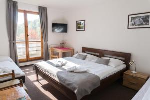 Postel nebo postele na pokoji v ubytování ProFamily Hotel TOP Benecko + 37 fotografií