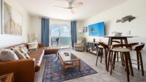a living room with a couch and a table at Whispering Palms Sea Gulls 210 in Key Largo