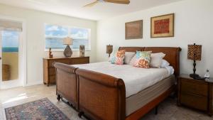 a bedroom with a bed with pillows on it at Whispering Palms Sea Gulls 210 in Key Largo +56 photos