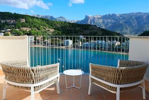 a balcony with two chairs and a view of the water at Salino Port Soller-Adults Only in Port de Soller