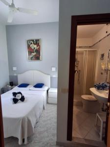 a hotel room with two beds and a bathroom at Hotel Castelfidardo in Rome