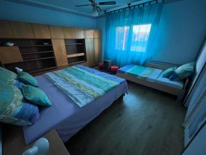 A bed or beds in a room at Abigél Apartman