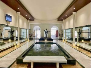 a large room with a pool of water in a building at Jungle Vibes Stay - 2 BR Beach Front & Balcony in Tangier