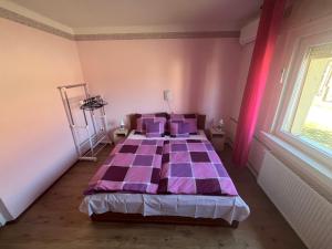 A bed or beds in a room at Abigél Apartman