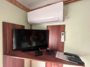 A television and/or entertainment centre at Abigél Apartman