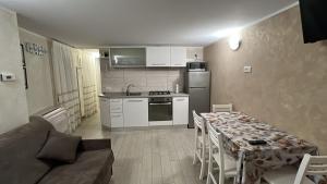a kitchen and a living room with a table and a couch at Dreams 116 Calle Cipolla in Chioggia