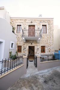 a building with a balcony on top of it at Apsinthium in Kalymnos