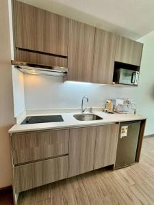 a kitchen with a sink and a stove at PRO HOME Balmaceda III in Antofagasta
