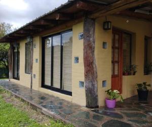 a house with a tree in front of it at El Silencio 2 - Quebrada - Lozano - Yala - Jujuy in Lozano