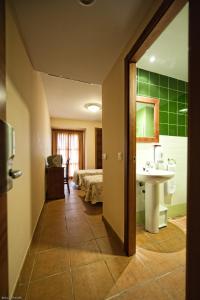 a bathroom with a sink and a bed in a room at Hotel Restaurante Campiña Del Rey in Villanueva del Rey