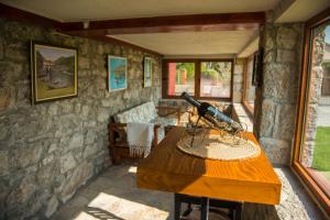 a wooden table with a gun on top of it at Konoba Stanisic in Balabani