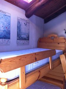two bunk beds in a room with wooden ceilings at Mansarda Jouvenceaux in Sauze dʼOulx