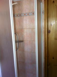 a bathroom with a shower with a glass door at Mansarda Jouvenceaux in Sauze dʼOulx