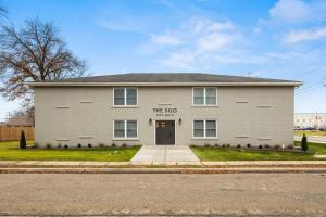 a gray building with the ape written on it at The Silo 6 - 1BD Modern Abode in Morton