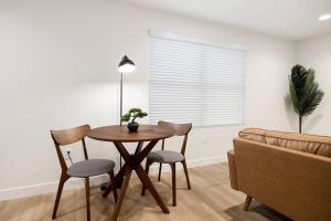 a living room with a table and chairs and a couch at The Silo 6 - 1BD Modern Abode in Morton +5 photos