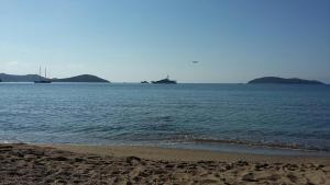 a view of the ocean with a ship in the distance at villakaterina skiathos in Megali Ammos