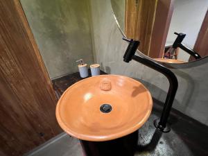 a bathroom with a wooden sink and a mirror at Pousada Ocazum Ilha do Amor in Alter do Chao