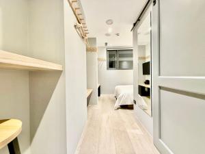 a small apartment with a hallway with a bedroom at N2 Hotel in Taichung