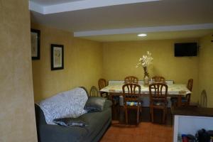 a living room with a table and chairs and a couch at La Alpargateria in Villafranca-Montes de Oca