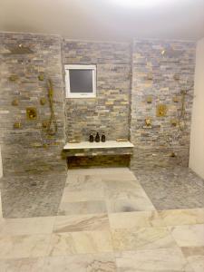 a bathroom with a sink and a stone wall at Balihamas Villa in Freeport +28 photos