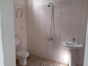 a bathroom with a toilet and a sink at Baafeh Beach in Sanyang +28 photos