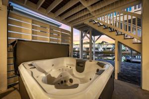 a large bath tub in a room with a balcony at Channel Catch in Myrtle Beach +80 photos