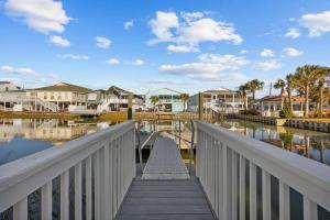 a bridge over a body of water with houses at Channel Catch in Myrtle Beach