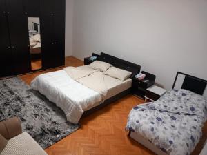 a bedroom with a bed and a mirror at Domi Apartment in Gjakove