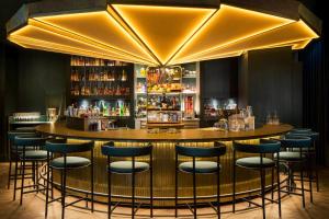 a bar with blue stools in a restaurant at Mandarin Oriental, Munich in Munich