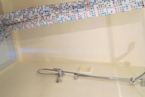 a glass shelf with a metal rail in a bathroom at Viva Riviera - 10 Rue Commandant André in Cannes