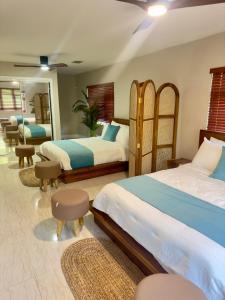 a bedroom with two beds and two chairs at Balihamas Villa in Freeport