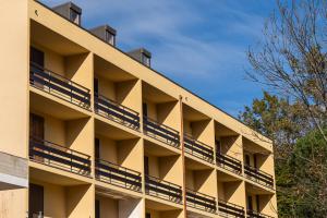an apartment building with balconies on the side of it at Casa il Rio in Riolunato