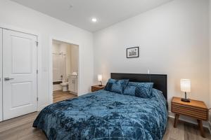 a bedroom with a large bed with a blue blanket at Tourist Home of Richmond - Church Hill North Apt08 in Richmond