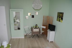 a living room with a table and a television at Hotel de Got in Villandraut