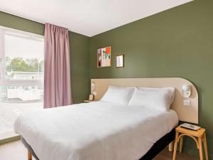 Ліжко або ліжка в номері greet Hôtel Prévessin Genève Aéroport
