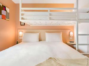 Ліжко або ліжка в номері greet Hôtel Prévessin Genève Aéroport