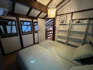 a bedroom with a bed and a chandelier at La Colline Stavelot in Stavelot