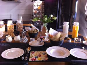 a table topped with plates of food and drinks at Skylark Bed & Breakfast in Grasse