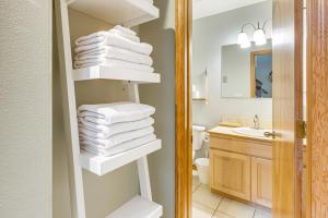 a bathroom with a stack of towels on a shelf at Rockaway Beach Home with Hot Tub 4 Blocks to Beach! in Rockaway Beach +21 photos