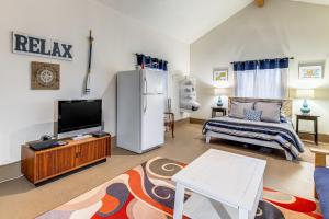 a living room with a refrigerator and a tv at Rockaway Beach Home with Hot Tub 4 Blocks to Beach! in Rockaway Beach